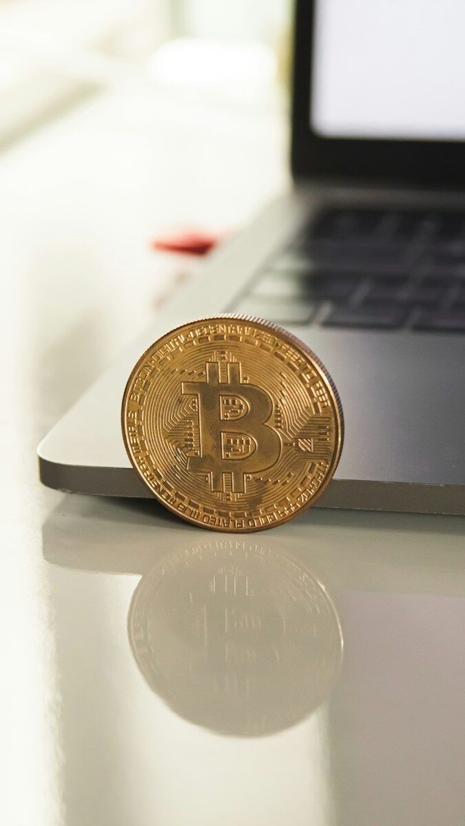 silver round coin on white table