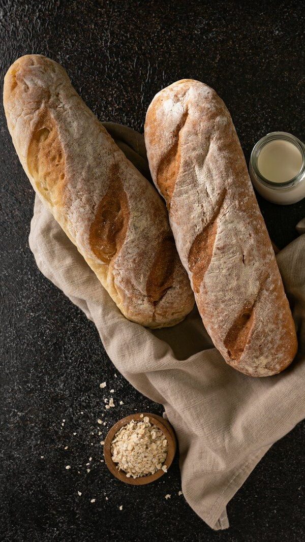 two loaves of bread sitting on top of a napkin