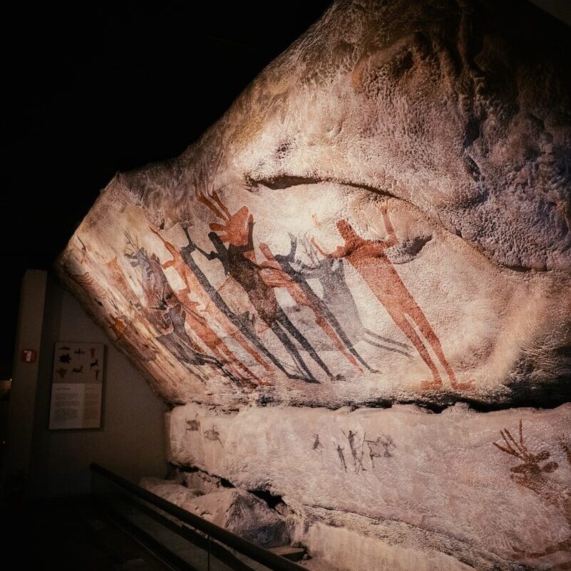 a close up of a rock with paintings on it