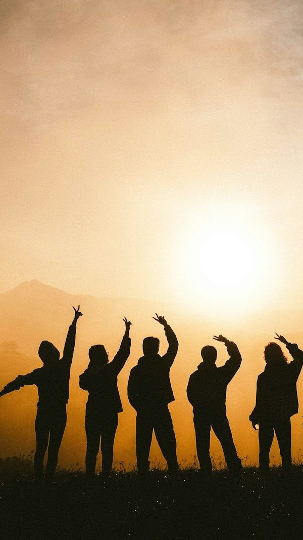 silhouette photo of six persons on top of mountain
