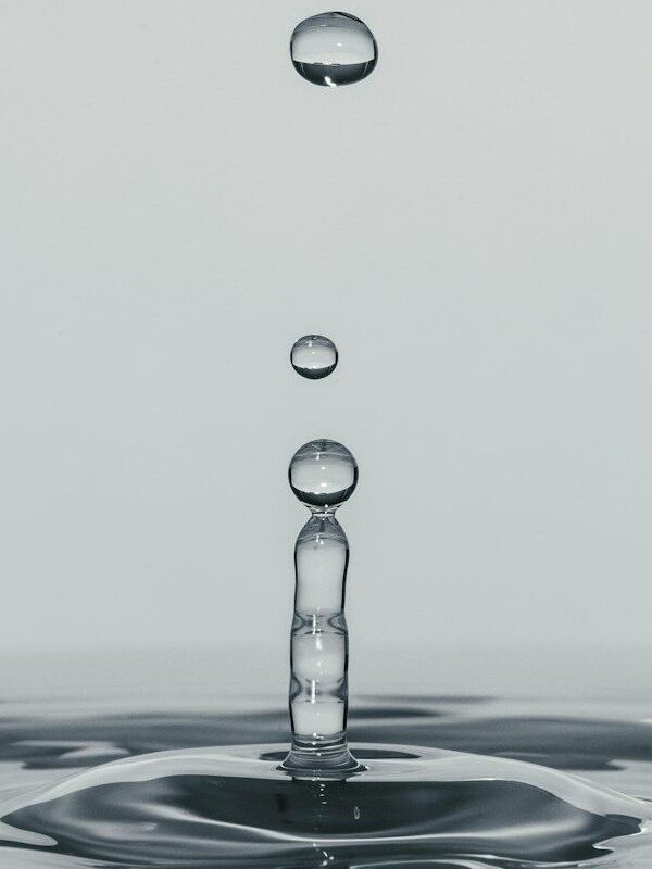 a drop of water falling into a body of water
