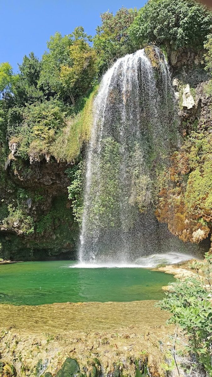 a waterfall over a body of water
